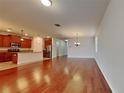 Open kitchen with wood cabinets, granite counters, and stainless steel appliances at 3537 Raleigh Dr, Winter Haven, FL 33884