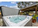 Relaxing hot tub with a covered patio nearby at 2028 Marker Rd, Polk City, FL 33868