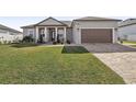 House exterior showcasing a two-car garage and manicured lawn at 7021 Bentridge Dr, Lakeland, FL 33813