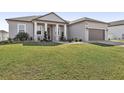 Tan house exterior, two car garage, well-maintained lawn at 7021 Bentridge Dr, Lakeland, FL 33813