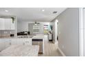Modern kitchen with white shaker cabinets, stainless steel appliances, and an island at 1314 W Highland St, Lakeland, FL 33815