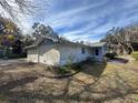 Side view of a light blue house needing some landscaping at 1401 Cr 449, Lake Panasoffkee, FL 33538