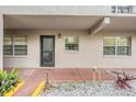 Condo entryway with a private entrance and well-maintained landscaping at 150 El Dorado # 101, Winter Haven, FL 33884