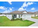 One-story house featuring a two-car garage and well-maintained lawn at 1125 Michelangelo Ln, Winter Haven, FL 33884