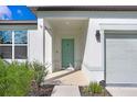 Inviting front entry with light teal door and covered porch at 1125 Michelangelo Ln, Winter Haven, FL 33884