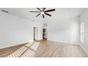 Bright and airy living room with vinyl plank flooring and ceiling fan at 223 Stanley Ave, Frostproof, FL 33843