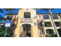 Condo building showcasing stairs, accessible parking, and landscaping at 713 Crest Pines Dr # 236, Orlando, FL 32828