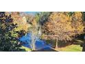 Tranquil pond view with lush trees and landscaping at 713 Crest Pines Dr # 236, Orlando, FL 32828