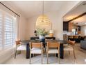 Modern dining room features an oval table, rattan light, and neutral decor at 1400 S Pennsylvania Ave, Winter Park, FL 32789