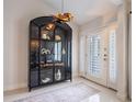 Bright entryway with a large, black curio cabinet and white door at 1400 S Pennsylvania Ave, Winter Park, FL 32789