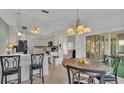 Bright kitchen with white cabinets, black appliances, and a breakfast bar at 4064 River Crest Cir, Leesburg, FL 34748