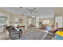 Open-concept living room featuring neutral walls, tile floors, and a ceiling fan at 4064 River Crest Cir, Leesburg, FL 34748