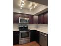 Modern kitchen featuring stainless steel appliances and dark cabinets at 190 Post Way, Casselberry, FL 32707