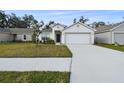 Newly built home with a two-car garage and well-manicured lawn at 1976 Thompson Preserve Blvd, Bartow, FL 33830