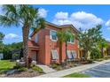 Townhome with a welcoming front entrance and lush landscaping at 4753 Vero Beach Pl, Kissimmee, FL 34746