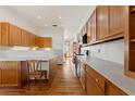 Kitchen with light wood cabinets and white countertops at 3060 Granada Dr, Indian Lake Estates, FL 33855