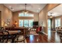 Bright living room featuring hardwood floors, vaulted ceilings and a cozy sitting area at 7006 Arcadian Ct, Mount Dora, FL 32757