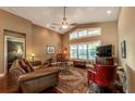 Open living room with hardwood floors, large windows and comfortable seating at 7006 Arcadian Ct, Mount Dora, FL 32757