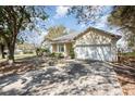 Charming single-story home with attached two-car garage and a long driveway at 422 W Division St, Clermont, FL 34715