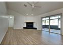 Spacious living room with wood floors, fireplace, and sliding glass doors at 6821 Rembrandt Dr, Orlando, FL 32818