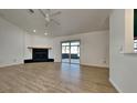 Living room with wood floors, fireplace and sliding glass doors leading to patio at 6821 Rembrandt Dr, Orlando, FL 32818