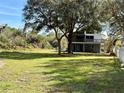 Spacious backyard with grassy area and mature trees at 2541 E Lake Dr, Deland, FL 32724