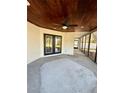 Covered patio with wood ceiling and French doors at 2541 E Lake Dr, Deland, FL 32724