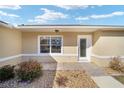 Inviting front entrance features a decorative glass door, landscaped surroundings, and attractive exterior finishes at 4629 Nw 30Th Pl, Ocala, FL 34482