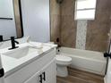 Renovated bathroom featuring modern vanity, bathtub, and stylish tile work at 5349 Hidden Oaks Dr, Lakeland, FL 33811