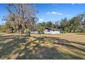 View of the home's side showcasing its clean lines and yard at 5525 Tillman Rd, Lakeland, FL 33810