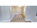 View of entryway with wood-look tile floor and door to exterior at 1650 Pine Ave, Mount Dora, FL 32757