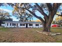 Newly renovated home with a white exterior, black windows, and landscaping at 3720 Willis Rd, Mulberry, FL 33860