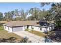 Single-story home with a large backyard and mature trees at 135 Country Club Ln, Mulberry, FL 33860