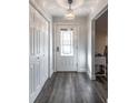 Bright entryway with white doors and grey wood-look floors at 135 Country Club Ln, Mulberry, FL 33860