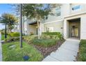Inviting townhome featuring lush landscaping and covered entryway at 760 Pebble Beach Dr, Davenport, FL 33896