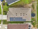 Aerial view showing solar panels on the roof of this single Gathering home at 1049 Augustus Dr, Davenport, FL 33896