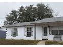 White, ranch-style home with shutters and small front porch at 1106 Avenue N, Haines City, FL 33844