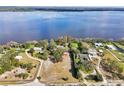 Aerial view of a lakeside home with a large lot, mature trees and direct water access at 8309 W Lake Marion Rd, Haines City, FL 33844