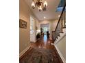 Elegant entryway with hardwood floors, chandelier, and staircase at 622 Penn Pl, Winter Park, FL 32789