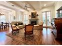 Spacious living room with hardwood floors, fireplace, and French doors at 622 Penn Pl, Winter Park, FL 32789