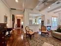 Open living room with hardwood floors and views into kitchen at 622 Penn Pl, Winter Park, FL 32789