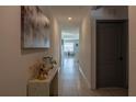 Bright hallway featuring tile floors, neutral walls, and an inviting view into the home at 637 Bernard Ln, Davenport, FL 33837