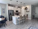 Modern kitchen with white cabinets, an island, and stainless steel appliances at 2503 Spring Breeze Dr, Leesburg, FL 34748