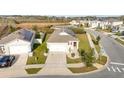 Real estate aerial view of a single-Gathering home with a two-car garage and manicured lawn at 812 Brooklet Dr, Davenport, FL 33837