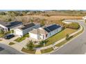 Aerial view of a modern single-Gathering home with solar panels and well-maintained landscaping at 812 Brooklet Dr, Davenport, FL 33837