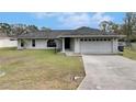 Charming single-story home featuring a well-maintained lawn, long driveway, and two-car garage at 1060 Colony Park Dr, Lakeland, FL 33813