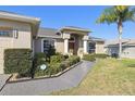 Inviting front exterior with meticulously maintained landscaping and a Ring doorbell for added security at 8867 Pebblebrooke Dr, Lakeland, FL 33810