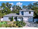 Charming two-story home with well-manicured lawn and a two car garage at 3911 Auburndale Ave, Orlando, FL 32839