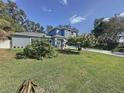 Well-manicured lawn and a two-story home with attached two car garage at 3911 Auburndale Ave, Orlando, FL 32839