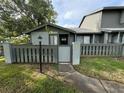 Inviting condo exterior with fenced-in patio and a view of the community pond at 200 Lemon Tree Ln # A, Ormond Beach, FL 32174